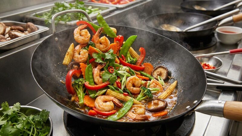 Colorful shrimp stir-fry with vegetables in a cooking pan