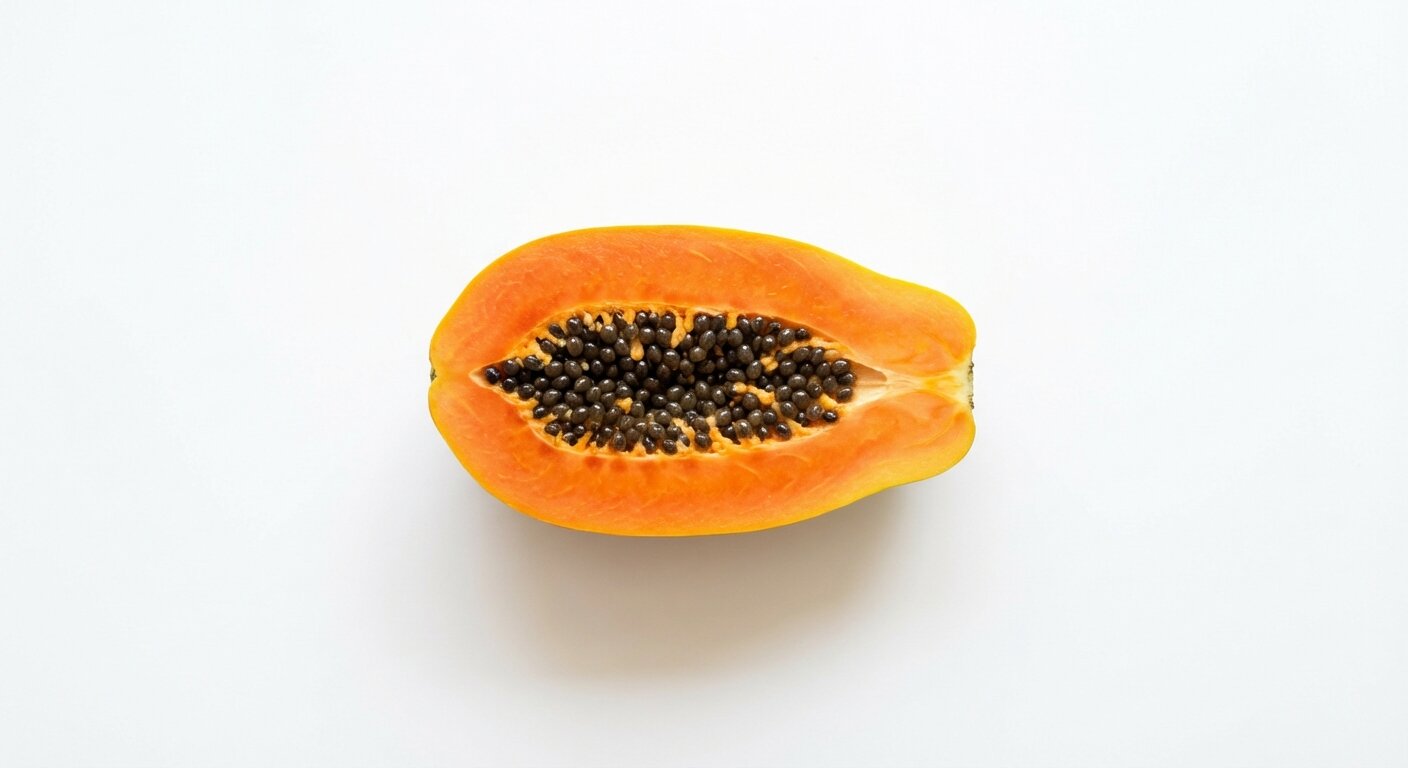 Fresh papaya fruit cut in half displaying bright orange flesh and black seeds on white background